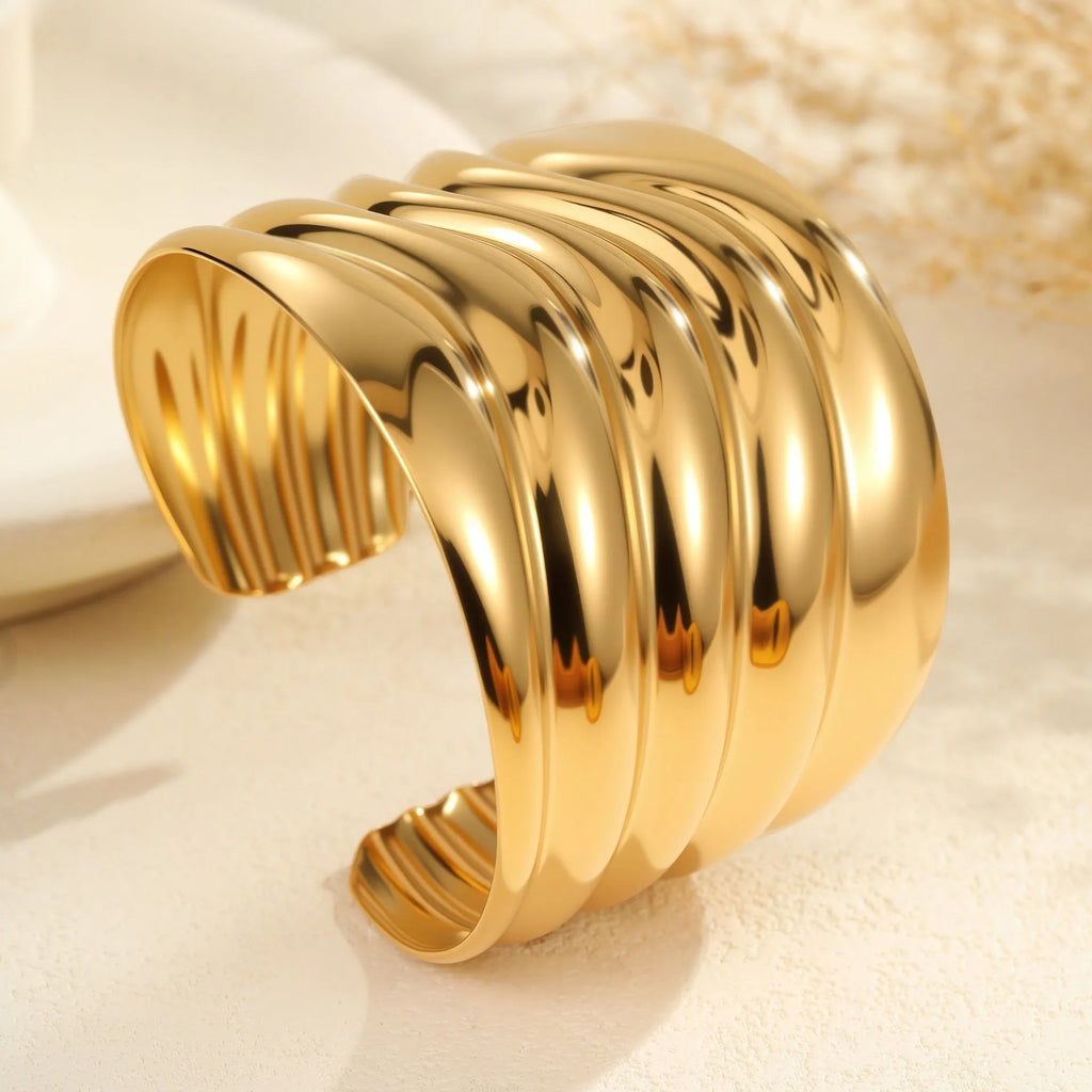 Women's gold-plated wide bracelet with stainless steel construction and geometric design