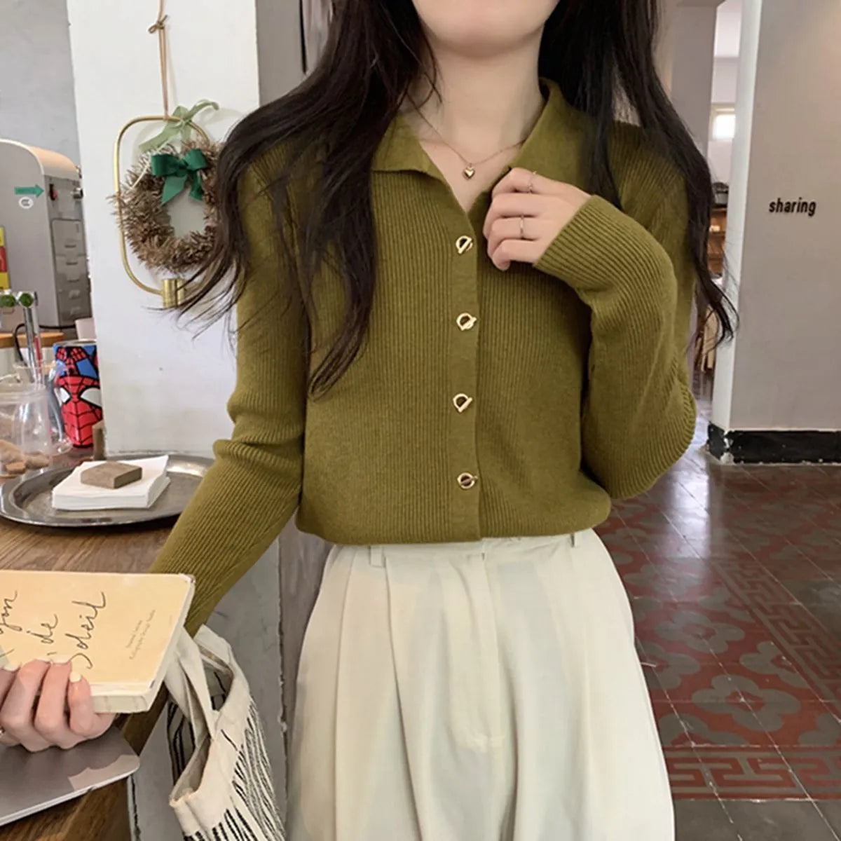 Loose fit knitted cardigan in beige, shown worn open as a long-sleeved top