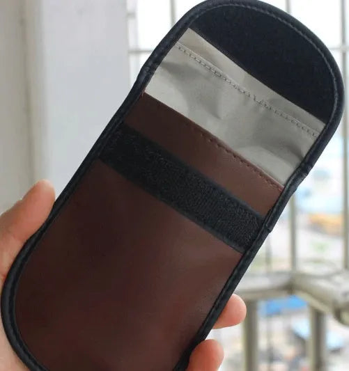Black microfiber Faraday cage pouch for blocking car key fob and smartphone RFID signals.