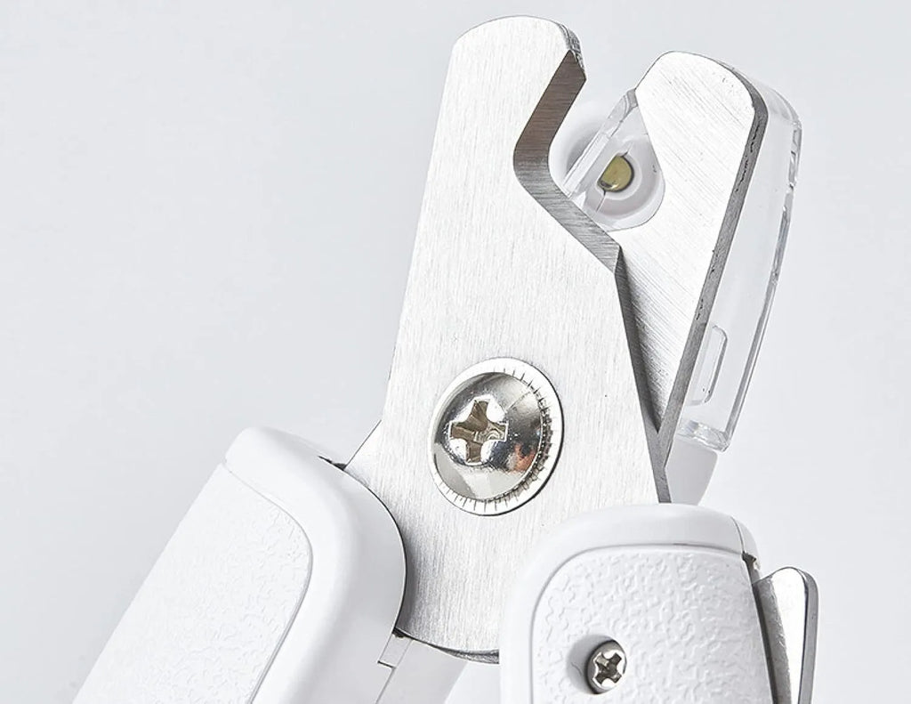 White pet nail clippers with LED light and transparent anti-splash guard for cats and dogs