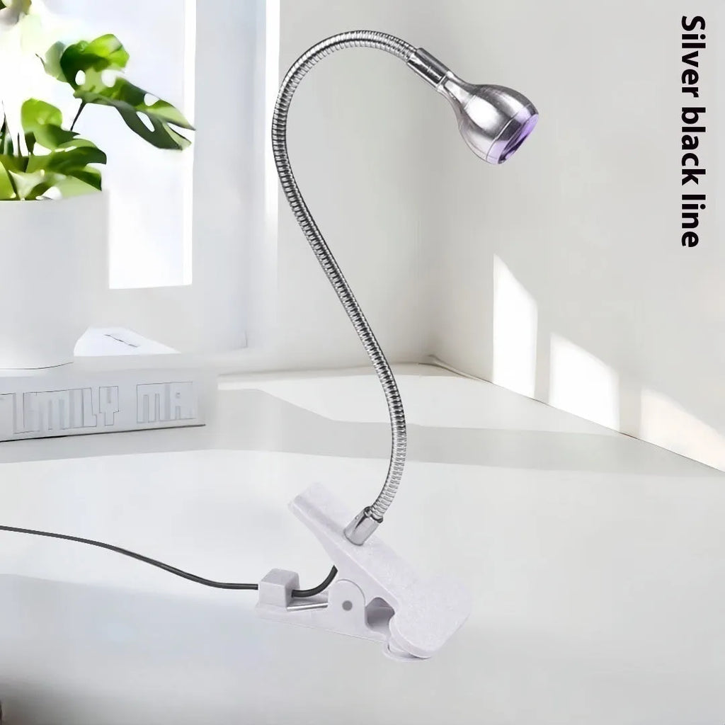 Goose neck nail lamp with USB clip, 395nm purple light curing UV glue on nails in a home manicure setting.