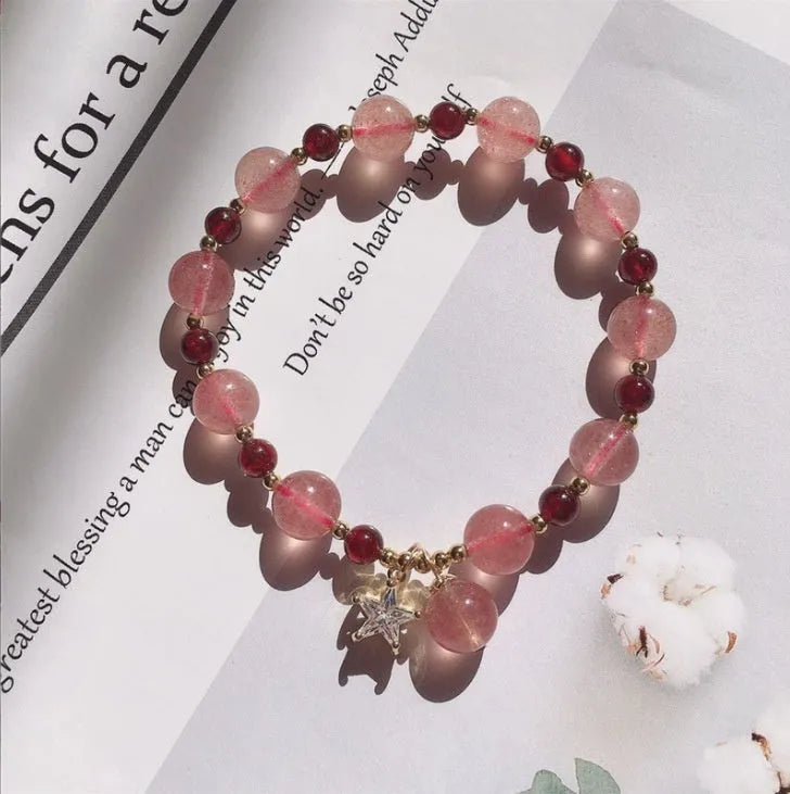 Handmade women's bracelet with strawberry quartz beads and Hetian jade peach blossom details.
