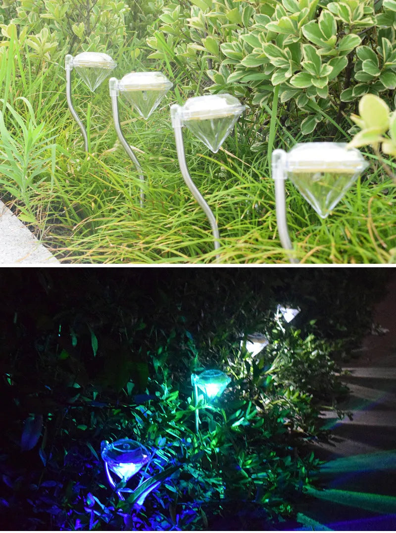 White solar-powered diamond-shaped garden spotlight with adjustable head on a stake.