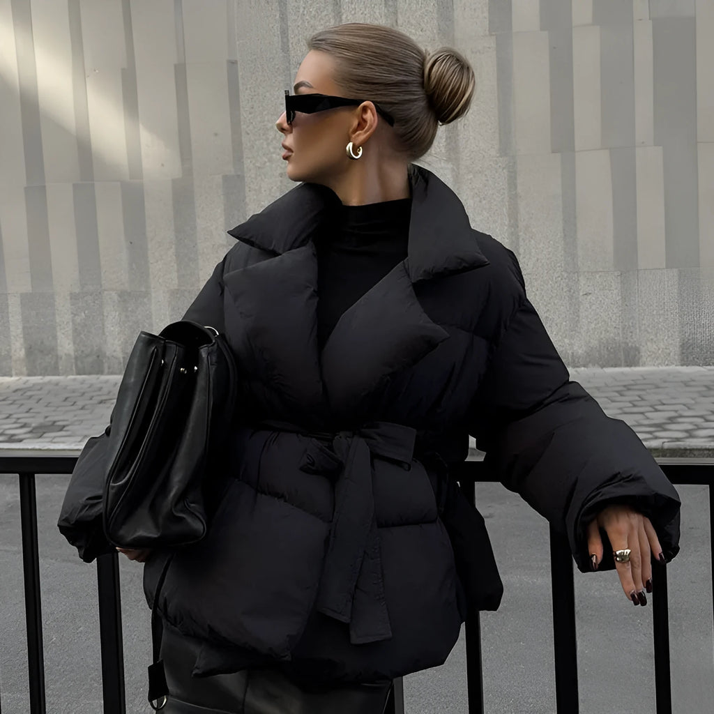 Waist-controlled lace-up lapel long sleeve polyester jacket in black with drawstring waist, front view.