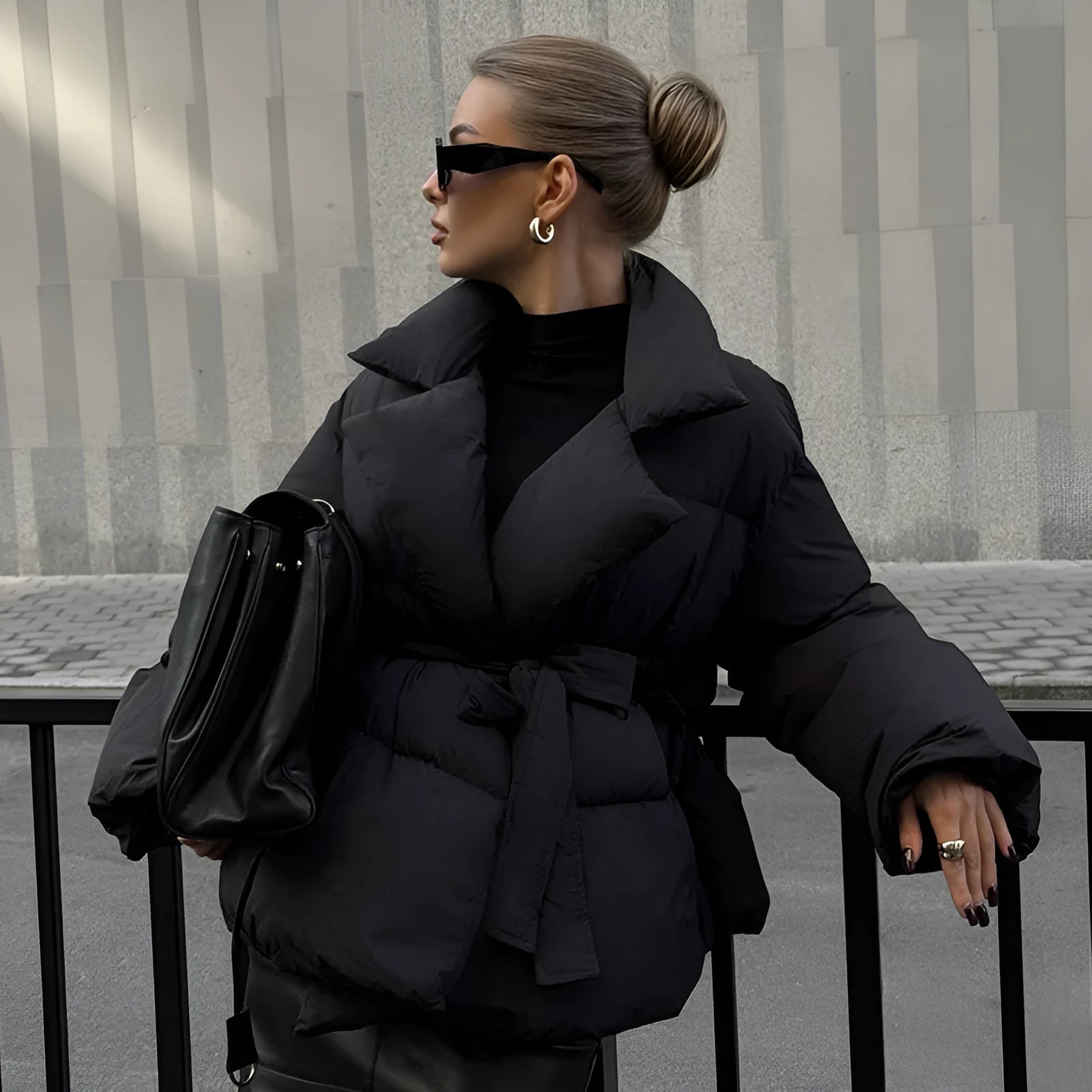 Waist-controlled lace-up lapel long sleeve polyester jacket in black with drawstring waist, front view.
