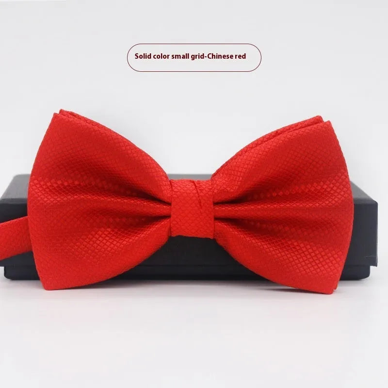 Solid colour flat head bow tie for formal wear in multiple colours including black, red, and blue.