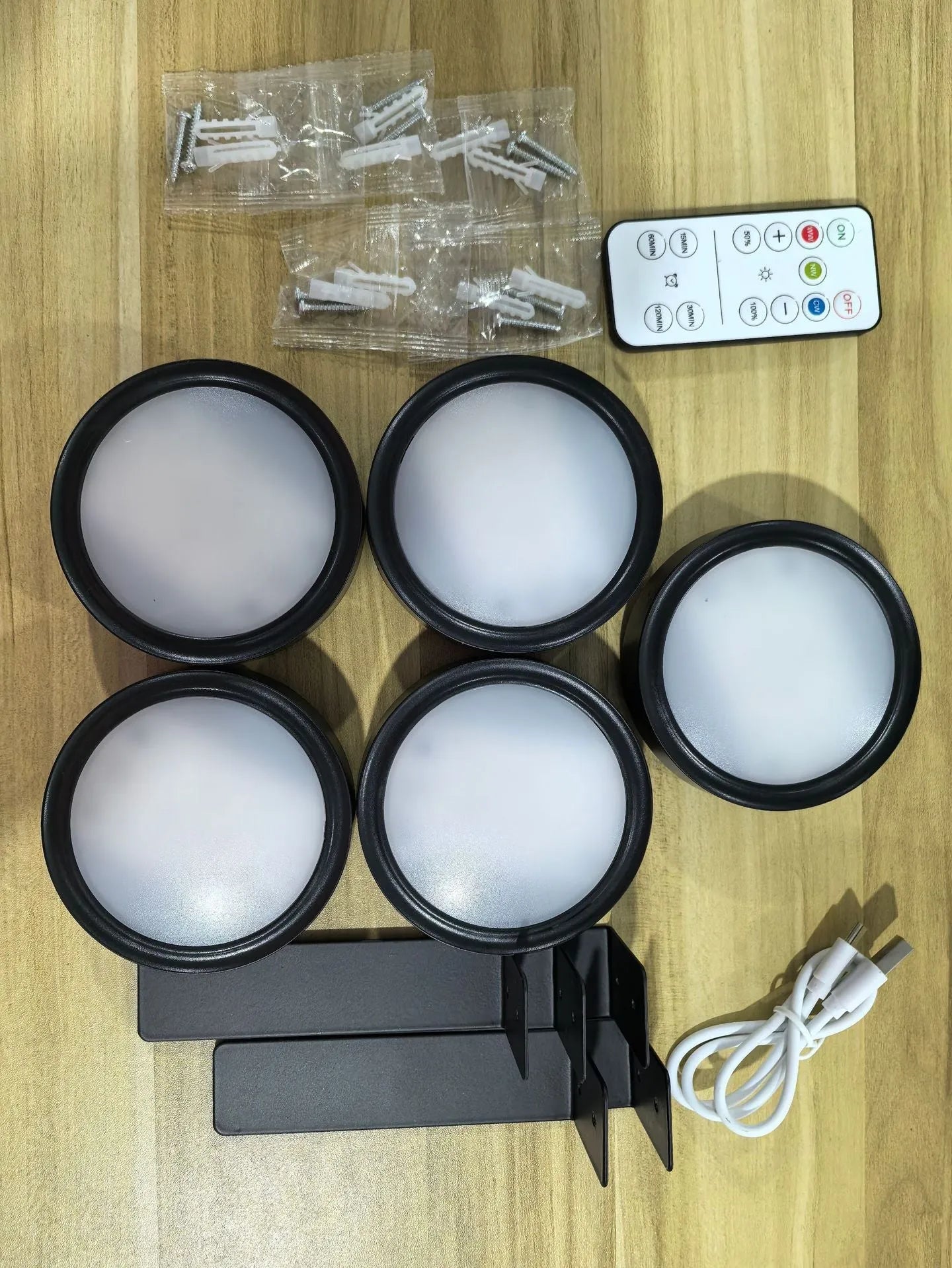 Wireless LED painting lamp with a magnetic mounting belt and remote control in black finish.