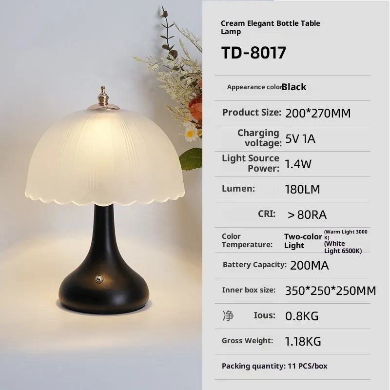 Geometric 3D table lamp in black with warm light on a wooden side table in a modern living room