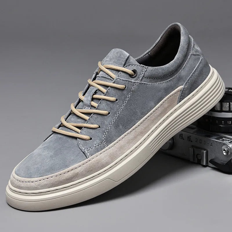 Men's grey pigskin leather casual skate shoes with flat rubber sole and lace-up front.