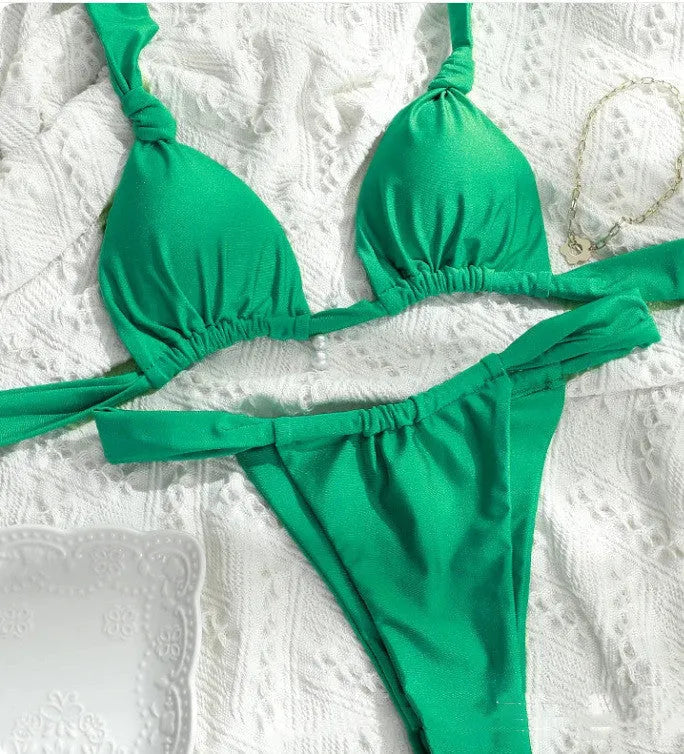 Women's pleated split strap bikini swimsuit in a solid colour with knotted detailing.