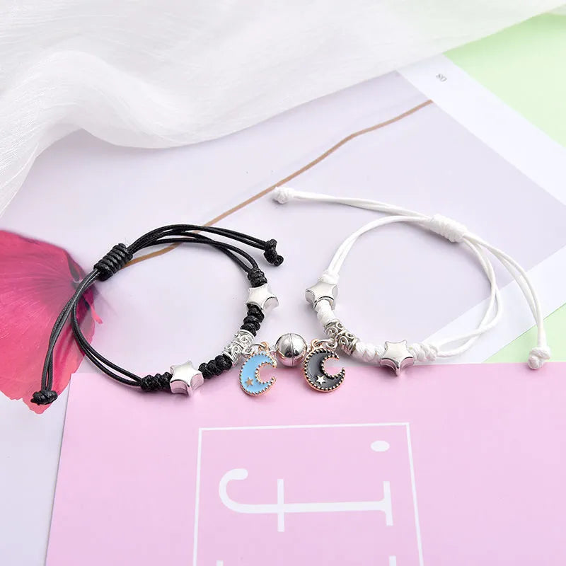 Magnetic clasp couple bracelets with alloy construction and symbolic designs including crown and love lock motifs.