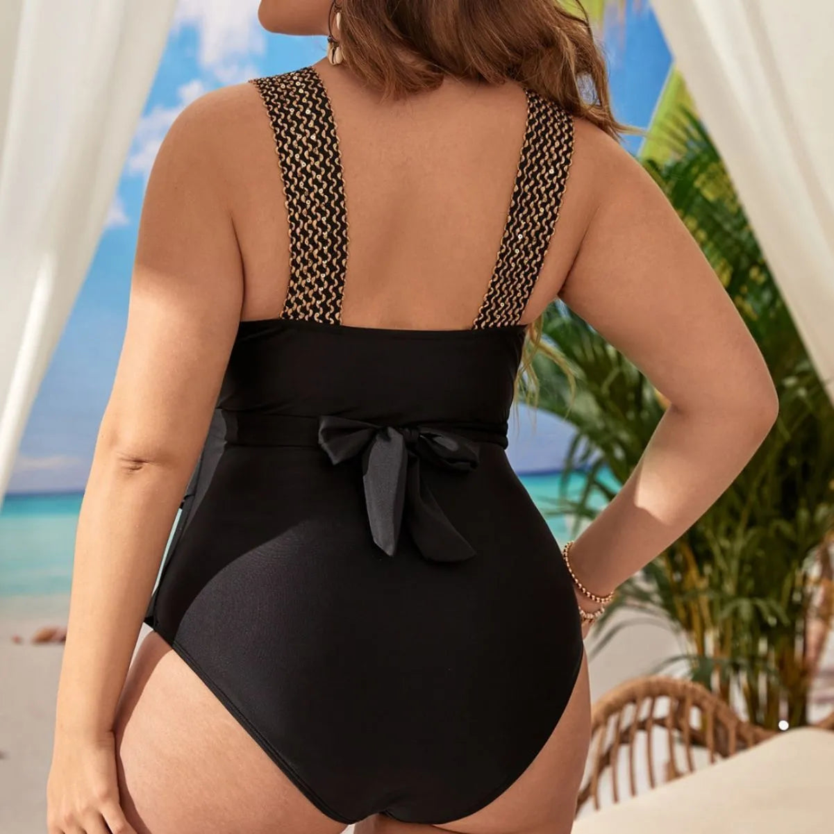 Plus-size women's one-piece sleeveless swimsuit on a hanger, showing removable chest pads and available colour options.