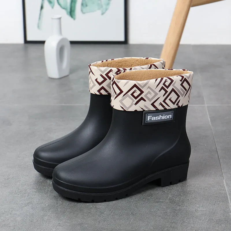 Women's mid-calf PVC rain boots in black with low heel design