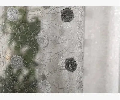 A single blackout curtain panel hung on a track, demonstrating its light-blocking fabric and hook-style header.