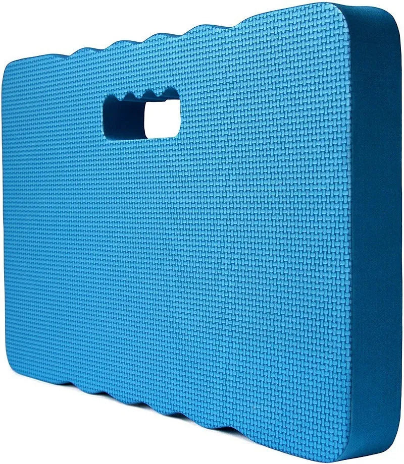 Blue EVA foam garden kneeler pad on grass, showing size next to gardening tools.
