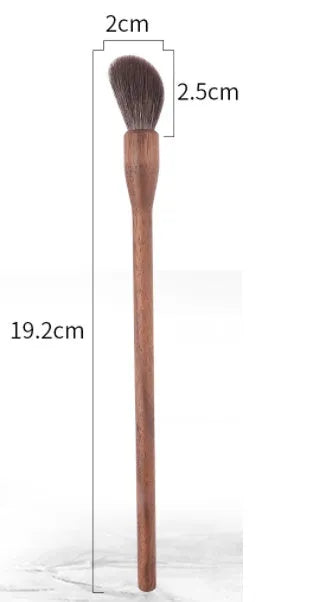 Set of 5 walnut eye makeup brushes with wool bristles on a flat surface.