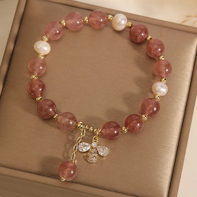 Women's bracelet with freshwater pearls, strawberry quartz stones, zircon accents and alloy bee charm