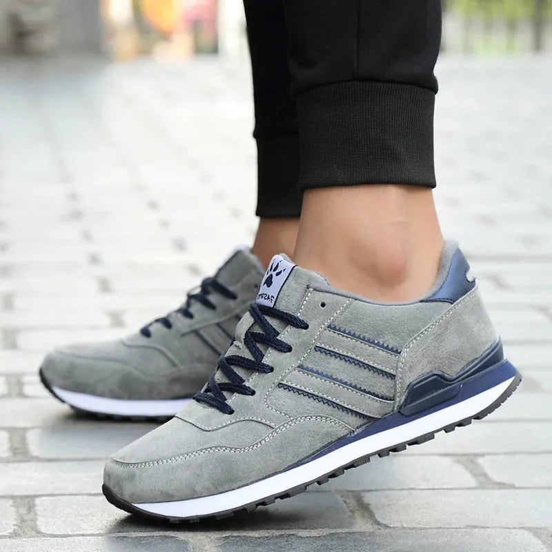 Blue leather sneakers for men with low-top design, pigskin upper, and rubber sole on a plain background