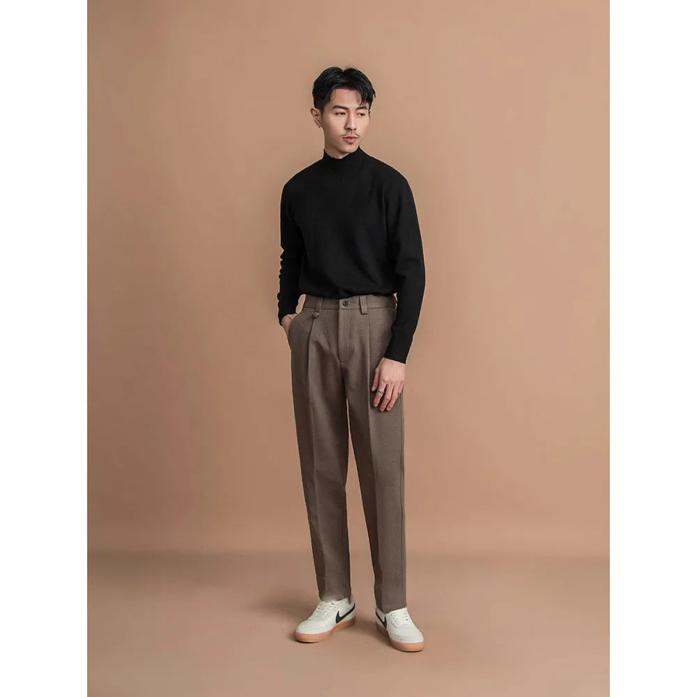 Man wearing grey straight leg polyester trousers for a smart casual look.