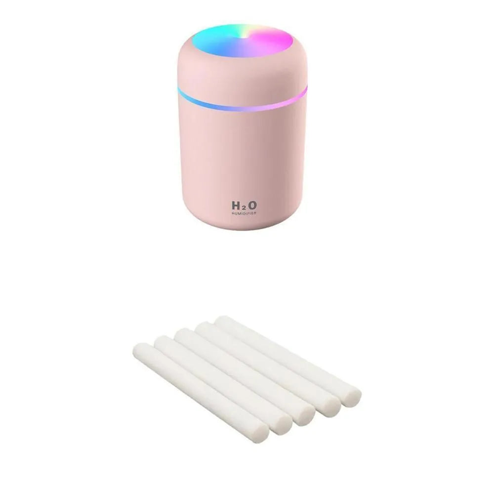 Pink USB desktop humidifier with colourful LED lights and 300ml water tank on wooden desk