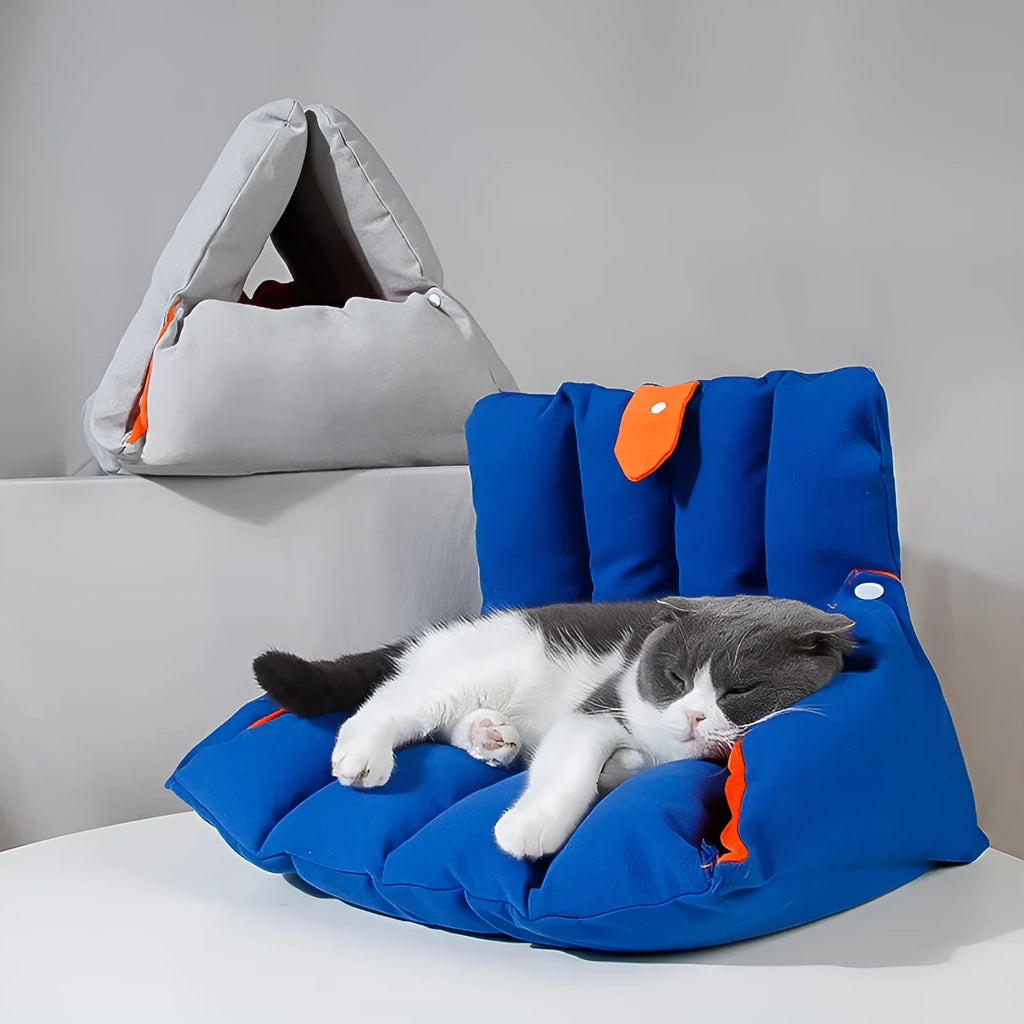 Blue triangular sofa-shaped cat nest with drilled holes for combination, showing removable cotton cover.
