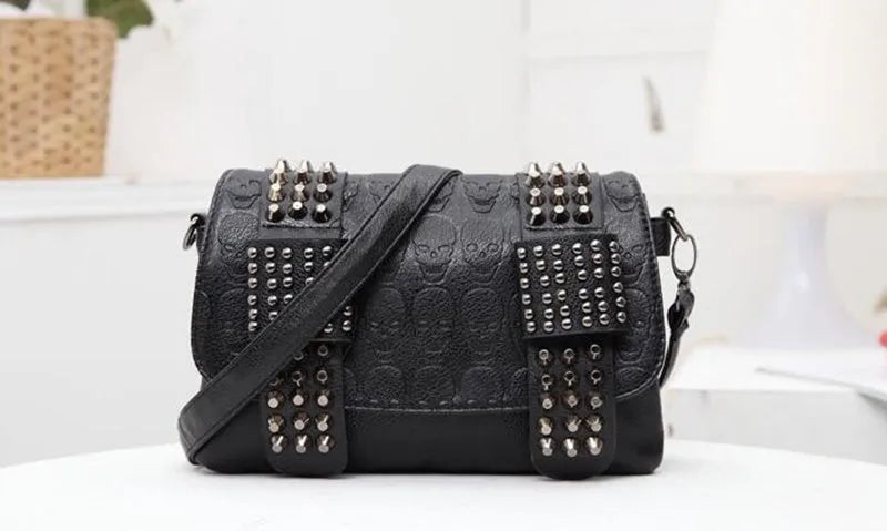 Black leather messenger bag with skull rivets and buckle closure for women