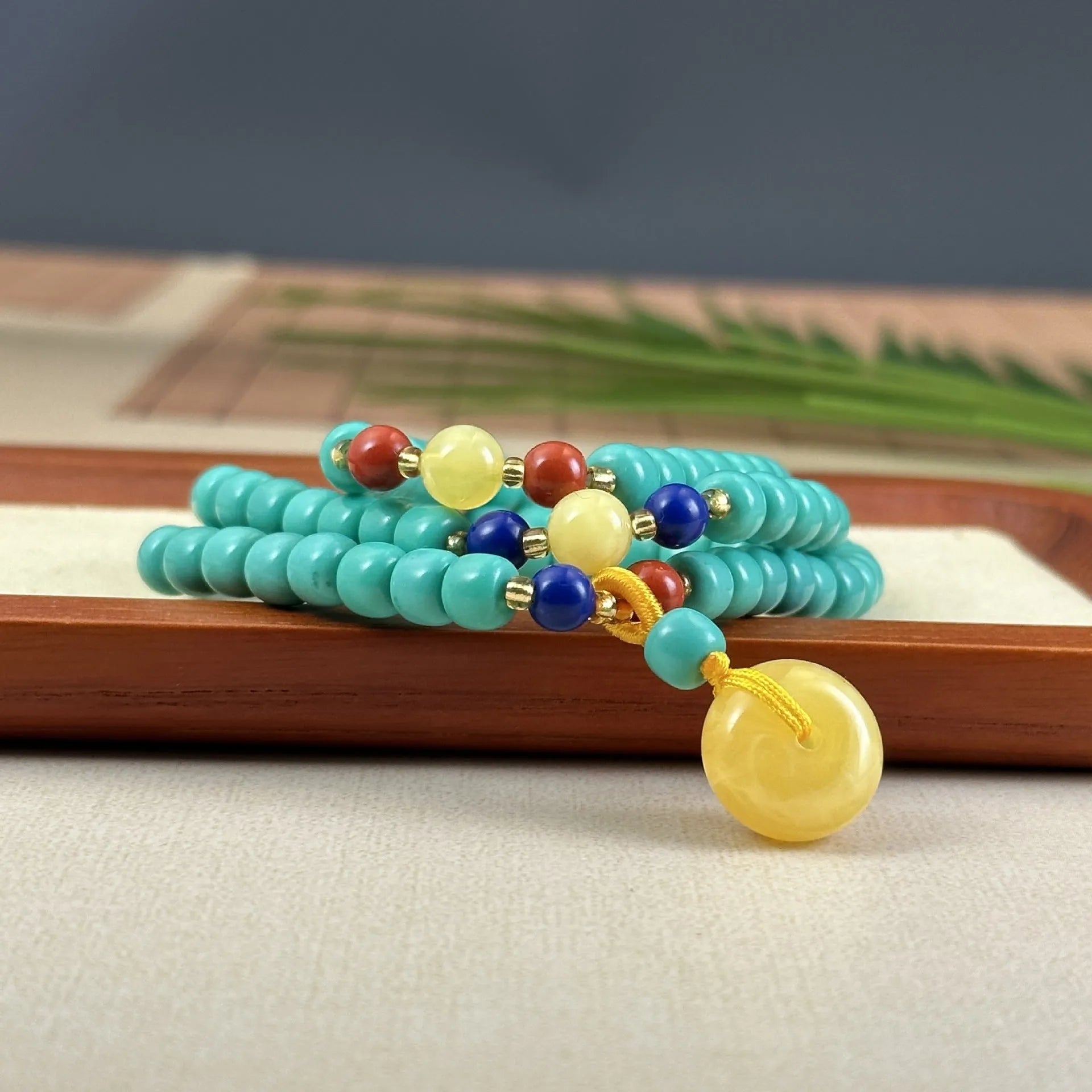 Turquoise stone pendant with hand-woven mesh flower design on adjustable ball bead necklace chain