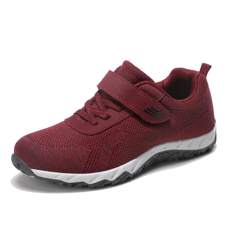 Women's grey purple low-top casual shoes with Velcro strap and wedge heel on a plain background.