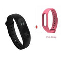 Black Xiaomi Mi Band 2 fitness tracker on wrist showing OLED display with heart rate reading