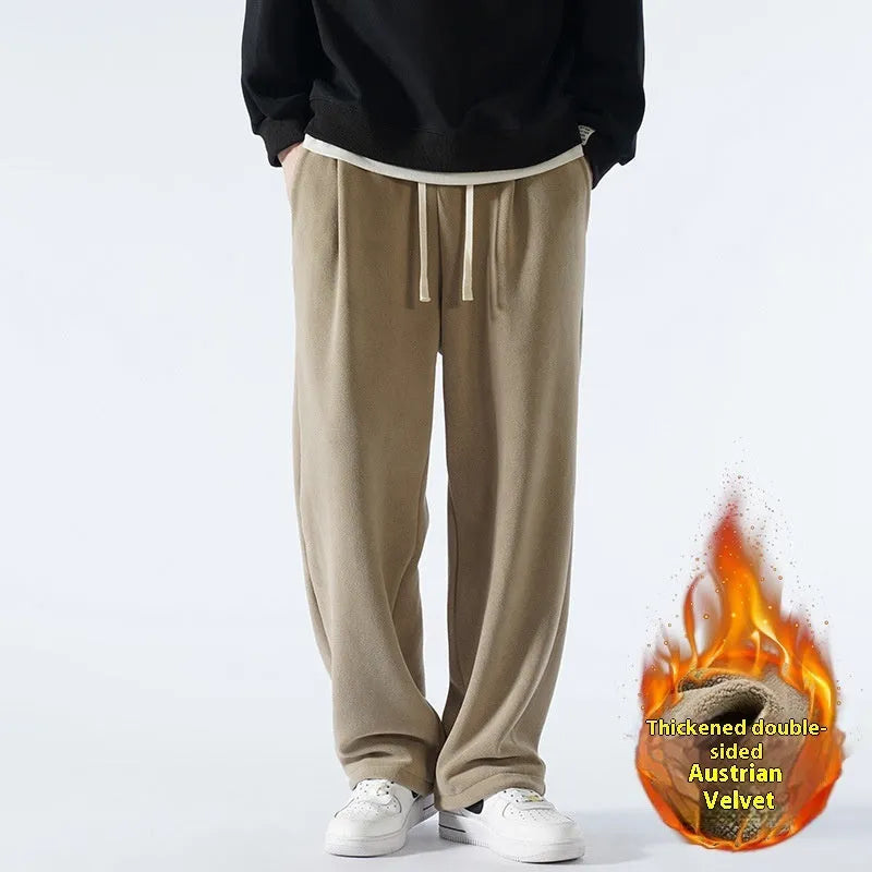 Men's double-sided polar fleece sports trousers in apricot, showing loose fit and drawstring waist.