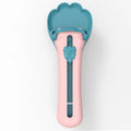 Green and pink pet feed spoon and snack squeezer tool for cat and dog food.