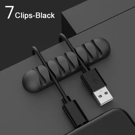 Smart cable holder with TPR flexible clips in black holding USB earphone and network cables on a desk