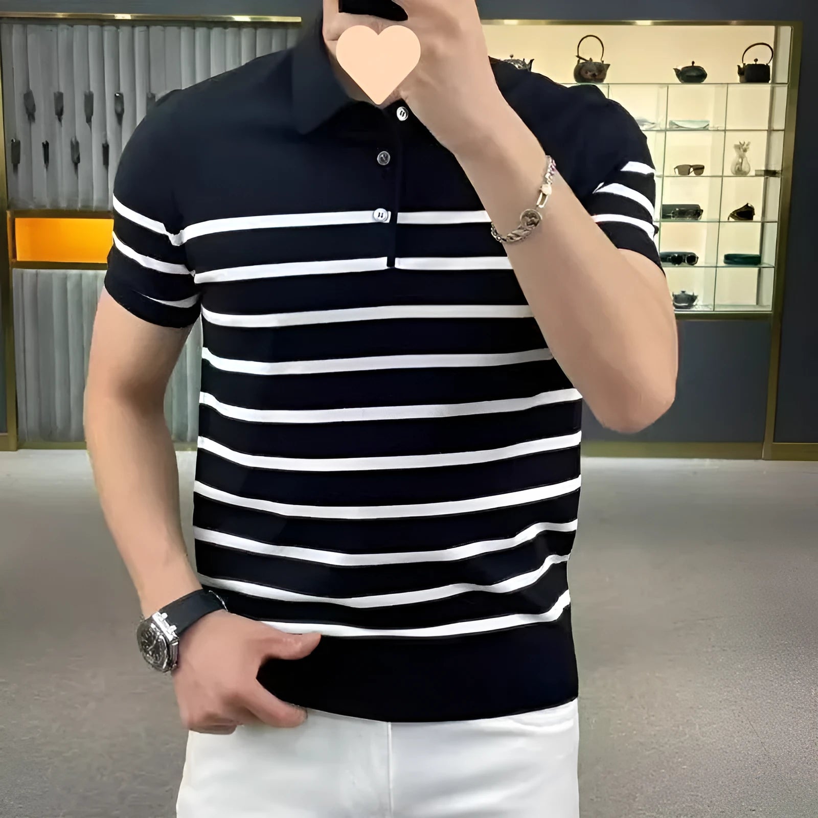 Man wearing a black and white striped knitted T-shirt with a lapel collar, casual style.
