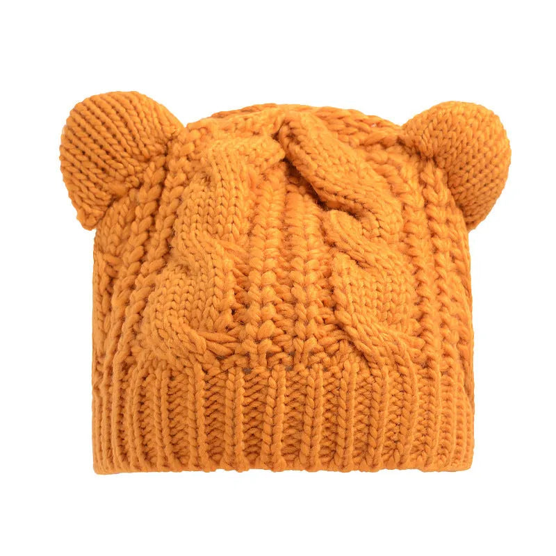 Hand made 3D knitted cat ear beanie in wool, shown in multiple colour options including red, black and beige.