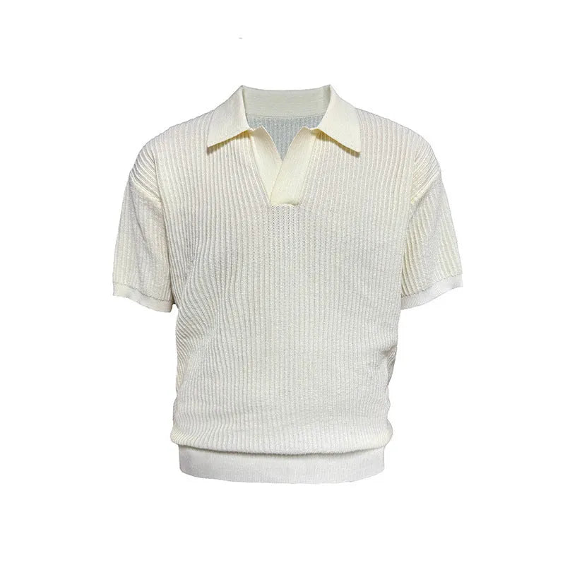 Man wearing a creamy-white loose fit short-sleeved polo shirt with a striped collar.