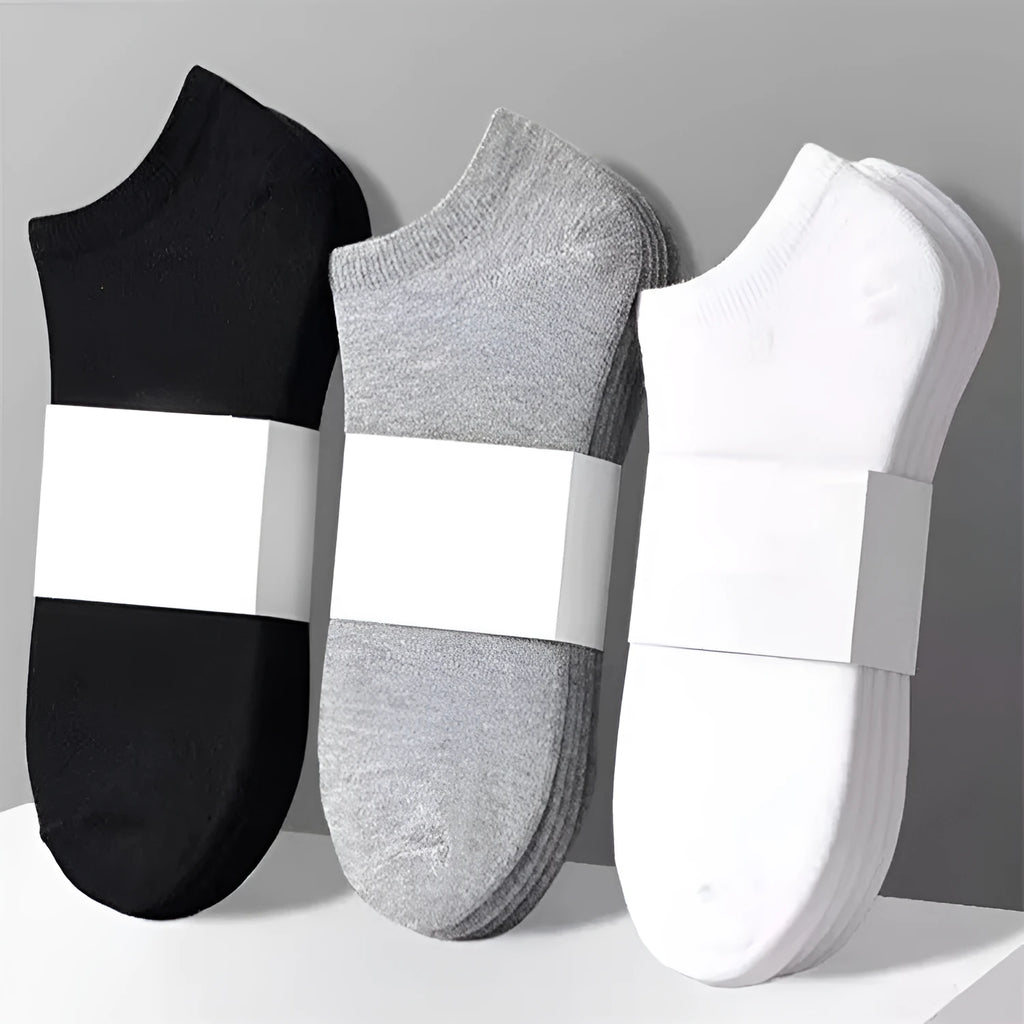 Solid colour men's low cut socks in black, grey, and white with seamless toe construction and blended fabric for breathability.