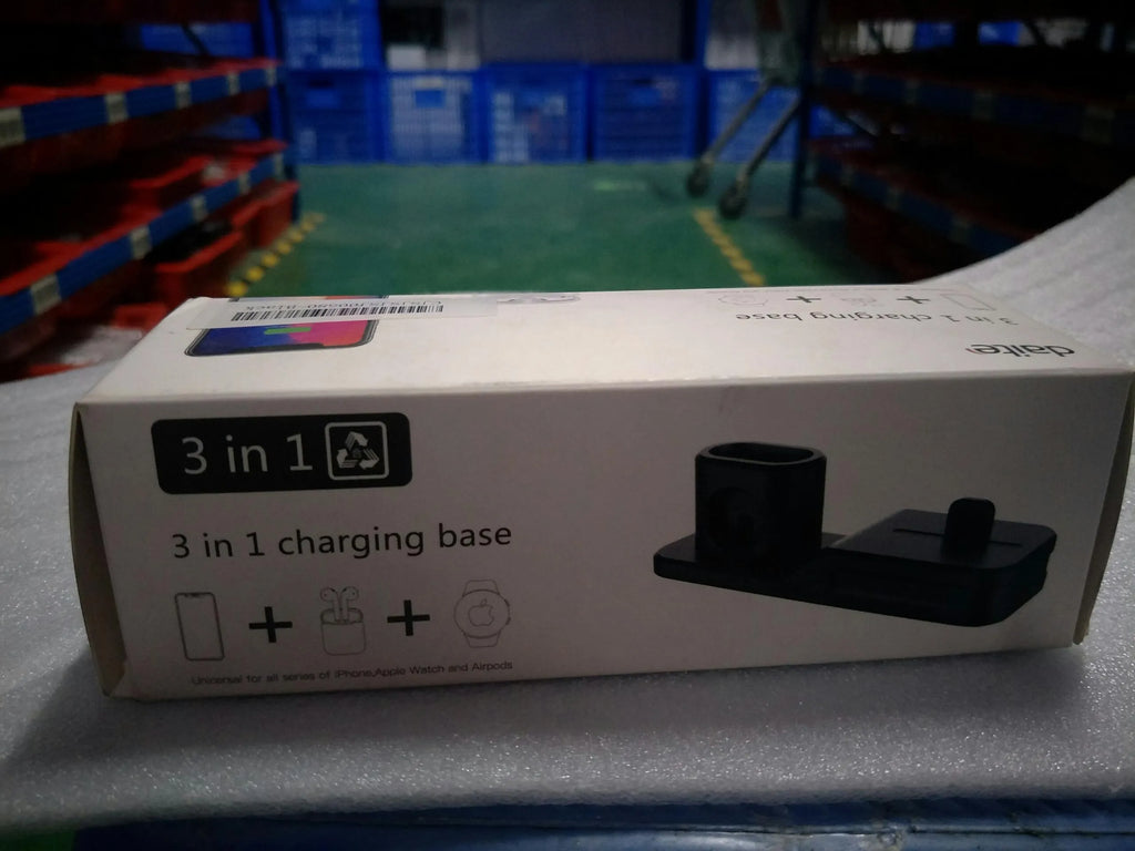 Black silicone 3-in-1 charging base for iPhone, iWatch, and AirPods on a plain surface
