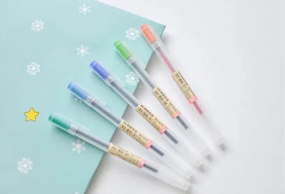 Set of 12 black Muji gel pens with 0.5mm nibs showing anti-leak ink mechanism detail