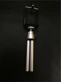 Black and silver desktop phone holder with two-section adjustable bracket on wooden desk