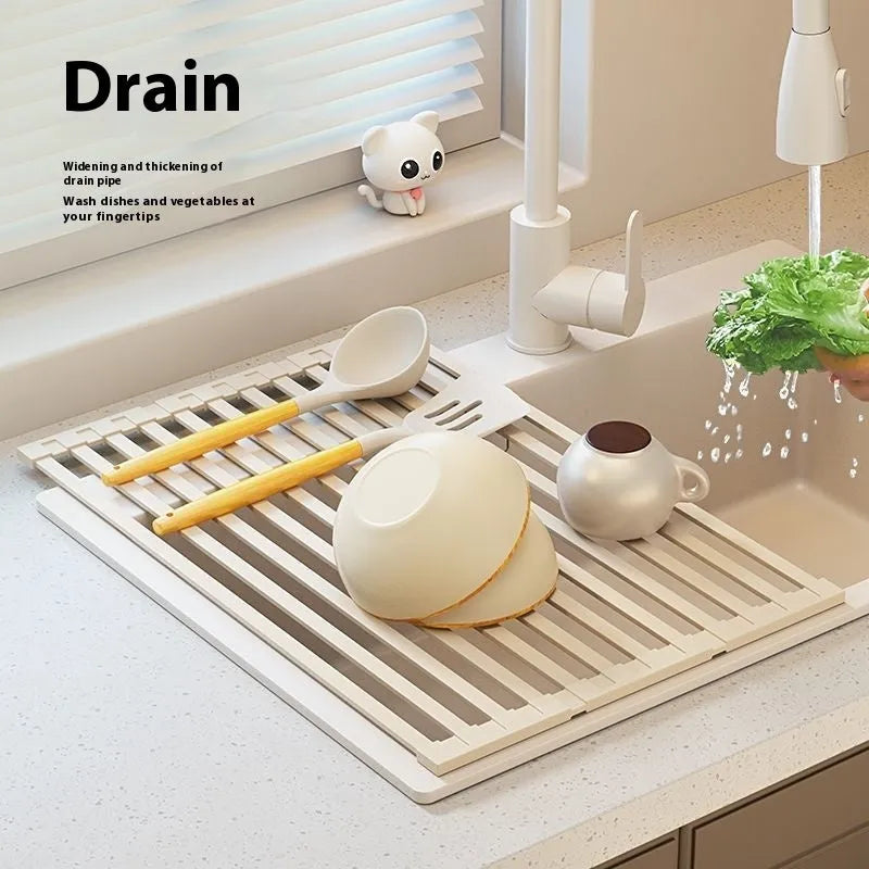 Milky white foldable stainless steel kitchen draining rack shown in a sink.