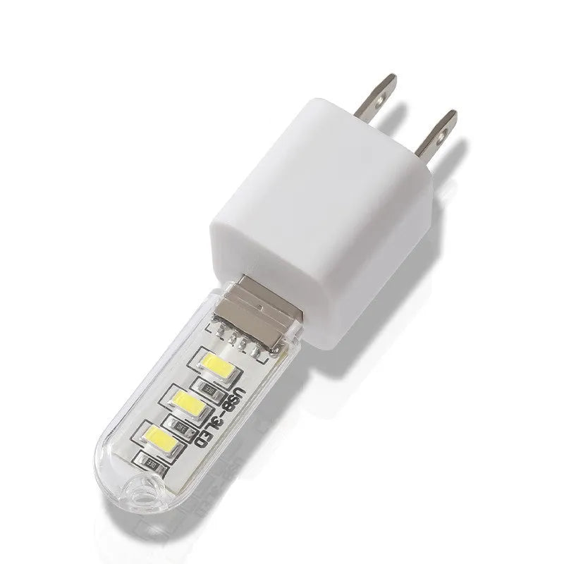 Small white cylindrical USB LED night light showing white and warm light colour options.