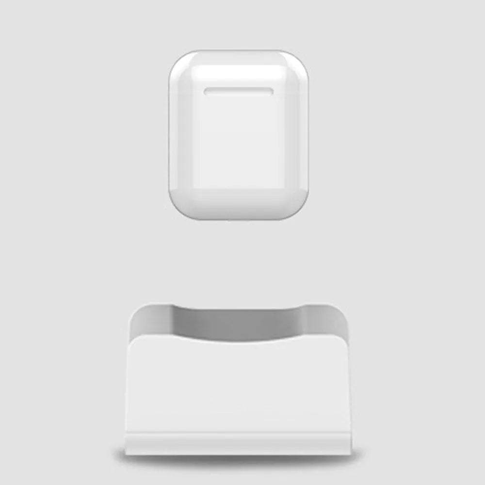 White headphone charging base stand on a desktop holding a gaming headset