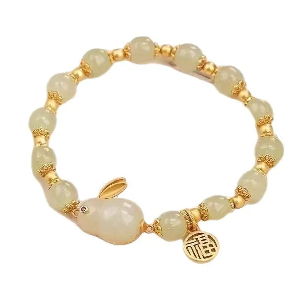 Green jade hare charm bracelet with black hand band showing lily engravings and fu character detail