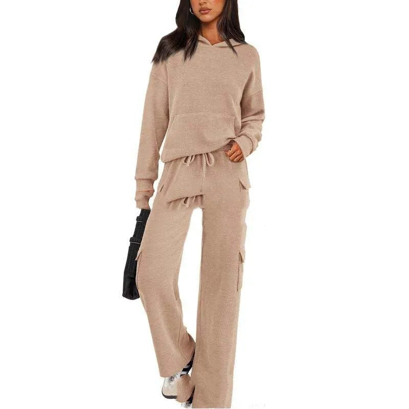 Women's black polyester leisure sports suit set with long sleeves and trousers laid flat.