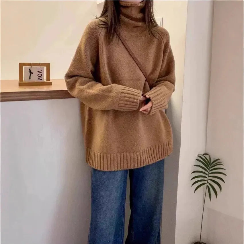 Women's loose grey turtleneck sweater with a thick, textured curling pile collar