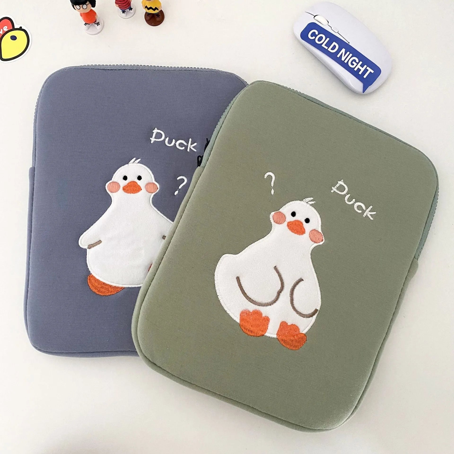 Blue tablet case with embroidered cartoon duck design and zipper closure