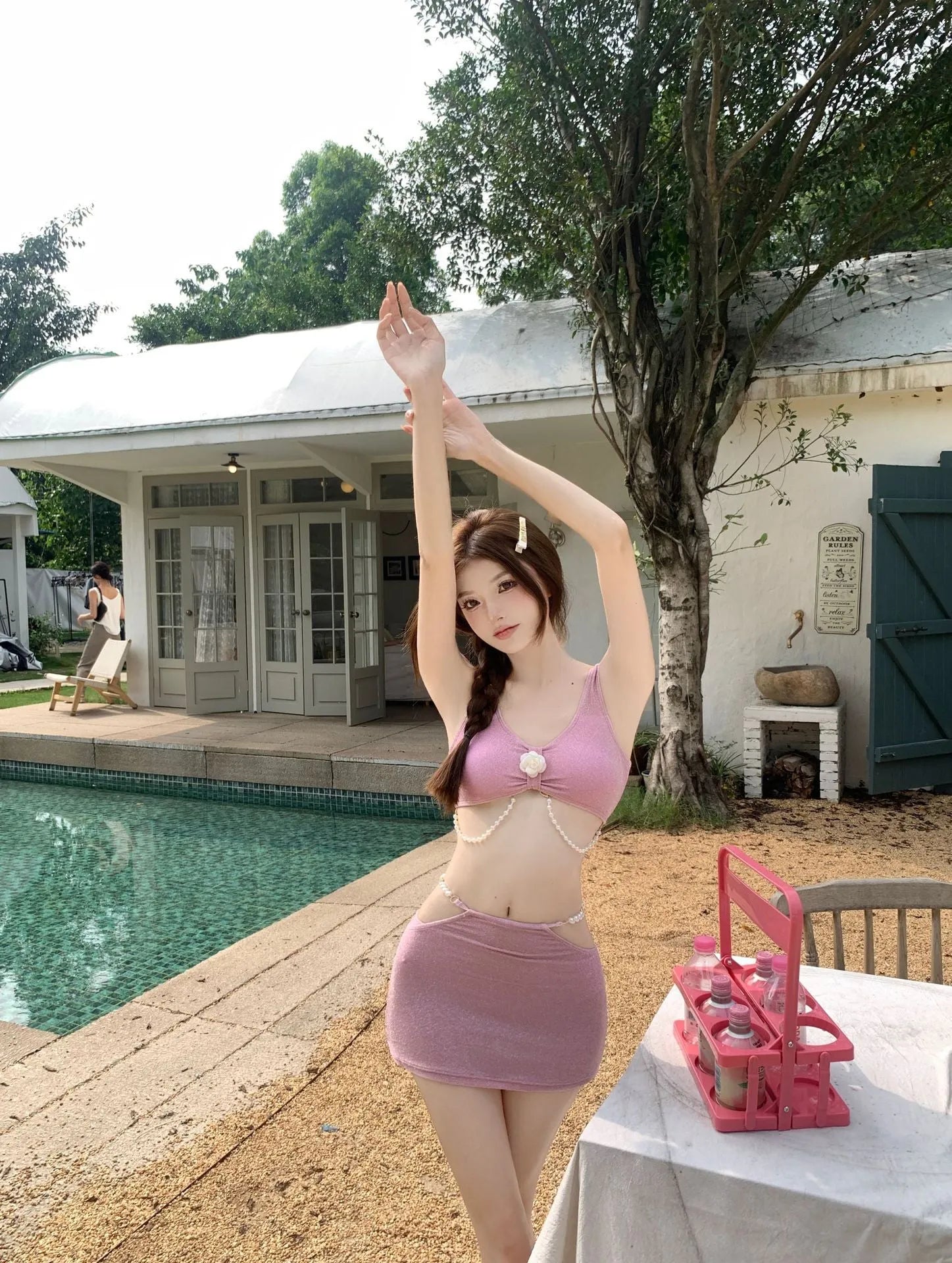 Women's pink and black three-piece bikini swimsuit set with briefs, made from high elasticity polyester fabric.