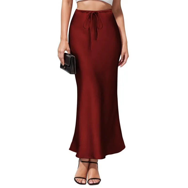 Women's asymmetric acetate satin skirt in a solid colour with high waist and irregular stitching detail.
