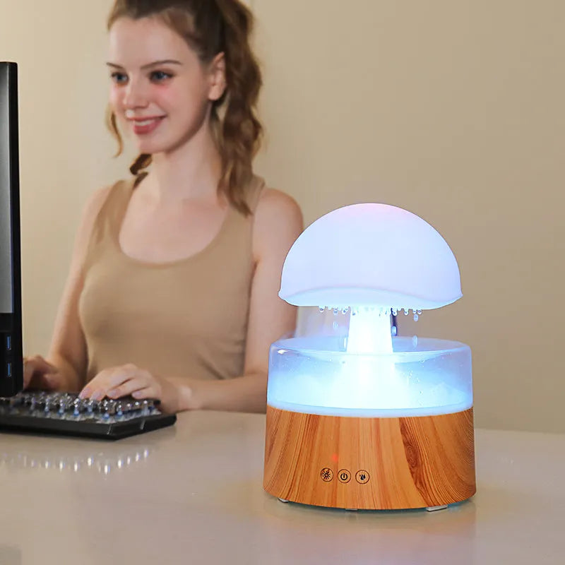 White cloud-shaped ultrasonic humidifier and aroma diffuser with colourful lighting and simulated raindrops