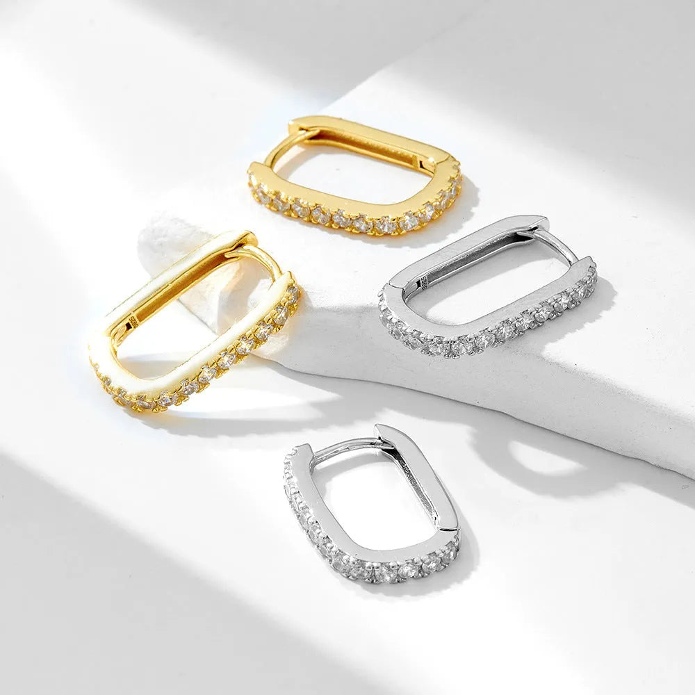 Sterling silver oval zircon ear clips with geometric design in white or yellow finish